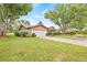 Single-story home featuring a well-maintained lawn and landscape at 1880 Oak Bark Ct, Clearwater, FL 33763
