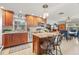 Updated kitchen with an island, stainless steel appliances, granite countertops, and wooden cabinets, open to a dining area at 1880 Oak Bark Ct, Clearwater, FL 33763