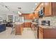 Modern kitchen featuring stainless steel appliances, granite countertops, and a center island with barstool seating at 1880 Oak Bark Ct, Clearwater, FL 33763