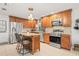 Updated kitchen with stainless steel appliances, granite countertops, a kitchen island, and ample wooden cabinetry at 1880 Oak Bark Ct, Clearwater, FL 33763