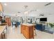 Open-concept kitchen and living room with a center island, dining table, and a comfortable seating area at 1880 Oak Bark Ct, Clearwater, FL 33763