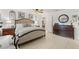 Cozy main bedroom with a large bed, tile flooring, and neutral decor at 1880 Oak Bark Ct, Clearwater, FL 33763