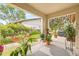 Covered patio with potted plants, offering a serene outdoor living space at 1880 Oak Bark Ct, Clearwater, FL 33763