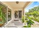 Charming covered patio with sliding glass doors, plants, and a stylish rug at 1880 Oak Bark Ct, Clearwater, FL 33763