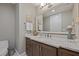 Elegant bathroom with a granite countertop, dark wood cabinets, and decorative accents at 2 Gulf Blvd, Indian Rocks Beach, FL 33785