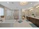 Elegant bathroom with a modern tub, glass shower, double vanity, and recessed lighting at 2 Gulf Blvd, Indian Rocks Beach, FL 33785