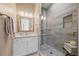Modern bathroom with a glass-enclosed shower, vanity, and granite countertop at 2 Gulf Blvd, Indian Rocks Beach, FL 33785