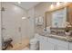 Bright bathroom with wave accent tile, a glass-enclosed shower, and a granite vanity at 2 Gulf Blvd, Indian Rocks Beach, FL 33785