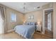 Cozy bedroom with light-colored walls, a ceiling fan, and a window with blinds at 2 Gulf Blvd, Indian Rocks Beach, FL 33785