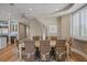 Elegant dining room with hardwood floors, seating for six, and a view of the modern, bright kitchen at 2 Gulf Blvd, Indian Rocks Beach, FL 33785
