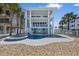 Three-story beach house featuring a pool, spa, and multiple balconies at 2 Gulf Blvd, Indian Rocks Beach, FL 33785