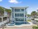 Three-story beach house features a pool, spa, and multiple balconies at 2 Gulf Blvd, Indian Rocks Beach, FL 33785