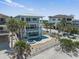 Stunning aerial view of a three-story beachfront home with a pool and spa at 2 Gulf Blvd, Indian Rocks Beach, FL 33785