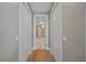 Hallway featuring wood floors, closet doors and partial view into another room at 2 Gulf Blvd, Indian Rocks Beach, FL 33785