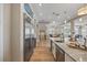Open-concept kitchen with stainless steel appliances, marble countertops, and view of the dining and living area at 2 Gulf Blvd, Indian Rocks Beach, FL 33785