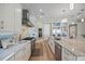 Gourmet kitchen with white cabinetry, marble countertops, and stainless steel appliances offers a stylish and functional cooking space at 2 Gulf Blvd, Indian Rocks Beach, FL 33785