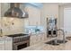 Gourmet kitchen features a stainless steel range hood and modern appliances, perfect for cooking at 2 Gulf Blvd, Indian Rocks Beach, FL 33785