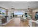Spacious living room featuring open floor plan, ceiling fans, and sliding glass doors with ocean view at 2 Gulf Blvd, Indian Rocks Beach, FL 33785