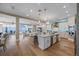 Spacious open-concept living space showcasing a kitchen, dining area, and living room with beautiful hardwood floors at 2 Gulf Blvd, Indian Rocks Beach, FL 33785