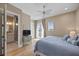 Comfortable main bedroom featuring a ceiling fan, balcony access, and an ensuite bathroom at 2 Gulf Blvd, Indian Rocks Beach, FL 33785