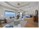 Luxurious bedroom featuring a sitting area, ocean views, tray ceiling, and hardwood floors at 2 Gulf Blvd, Indian Rocks Beach, FL 33785