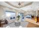 Inviting bedroom boasts a sitting area with ocean views, tray ceiling, hardwood floors, and ensuite bathroom at 2 Gulf Blvd, Indian Rocks Beach, FL 33785