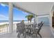Covered patio with bar stool seating offering beautiful views of the beach and nearby ocean at 2 Gulf Blvd, Indian Rocks Beach, FL 33785
