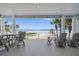 Spacious covered patio featuring beach views, relaxing seating, and outdoor dining space at 2 Gulf Blvd, Indian Rocks Beach, FL 33785