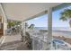 Covered patio boasting ocean views, lounge seating, dining area and access to the beach at 2 Gulf Blvd, Indian Rocks Beach, FL 33785
