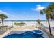 Pool and beach area with ocean views, private yard and lounge seating at 2 Gulf Blvd, Indian Rocks Beach, FL 33785