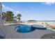 Beautiful pool and spa with ocean view, surrounded by palm trees at 2 Gulf Blvd, Indian Rocks Beach, FL 33785