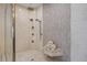Modern shower features dual shower heads, body jets, and a convenient tiled bench for a luxurious experience at 2 Gulf Blvd, Indian Rocks Beach, FL 33785