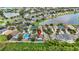 Aerial view of the neighborhood with mature trees and a serene pond nearby, and a private pool at 2330 Lawrence Hall St, Ruskin, FL 33570