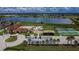 Aerial view showcasing community amenities, including a pool, playground, and sports courts by a lake at 2330 Lawrence Hall St, Ruskin, FL 33570