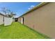 A well-maintained lawn with a white fence with pool in background at 2330 Lawrence Hall St, Ruskin, FL 33570