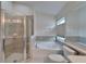 Bright bathroom featuring a glass shower, tub, and modern fixtures at 2330 Lawrence Hall St, Ruskin, FL 33570