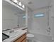 Bathroom with tiled shower and bathtub, vanity, and a mirror at 2330 Lawrence Hall St, Ruskin, FL 33570
