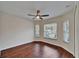 Bedroom with hardwood floors, a ceiling fan, and multiple windows at 2330 Lawrence Hall St, Ruskin, FL 33570