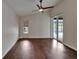 Bedroom with wood floors, ceiling fan, a window and a sliding glass door to a pool at 2330 Lawrence Hall St, Ruskin, FL 33570