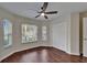 Bedroom with hardwood floors, a ceiling fan, a closet and multiple windows at 2330 Lawrence Hall St, Ruskin, FL 33570