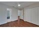 Bright bedroom featuring wood floors, and doors to an ensuite bathroom and closet at 2330 Lawrence Hall St, Ruskin, FL 33570