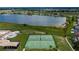 Aerial view of community tennis and basketball courts with a scenic lake backdrop at 2330 Lawrence Hall St, Ruskin, FL 33570