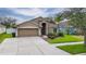 Charming single-story home featuring a well-maintained lawn and an attached two-car garage at 2330 Lawrence Hall St, Ruskin, FL 33570
