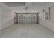 Spacious two-car garage features neutral walls, concrete flooring, and updated garage door at 2330 Lawrence Hall St, Ruskin, FL 33570