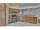 Kitchen showcasing stainless steel appliances, double oven, granite countertops, and tile flooring at 2330 Lawrence Hall St, Ruskin, FL 33570