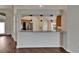 Eat-in kitchen featuring a bar with granite countertops and wooden floors at 2330 Lawrence Hall St, Ruskin, FL 33570