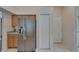 Kitchen featuring stainless steel refrigerator, granite countertops, and light wood cabinets at 2330 Lawrence Hall St, Ruskin, FL 33570