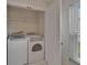 Bright laundry area features a new washer and dryer and shelving at 2330 Lawrence Hall St, Ruskin, FL 33570