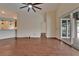 Spacious living room with hardwood floors, a ceiling fan, and sliding doors to the pool at 2330 Lawrence Hall St, Ruskin, FL 33570