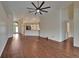 Large living room showcasing an open layout, hardwood floors, and access to the kitchen and foyer at 2330 Lawrence Hall St, Ruskin, FL 33570